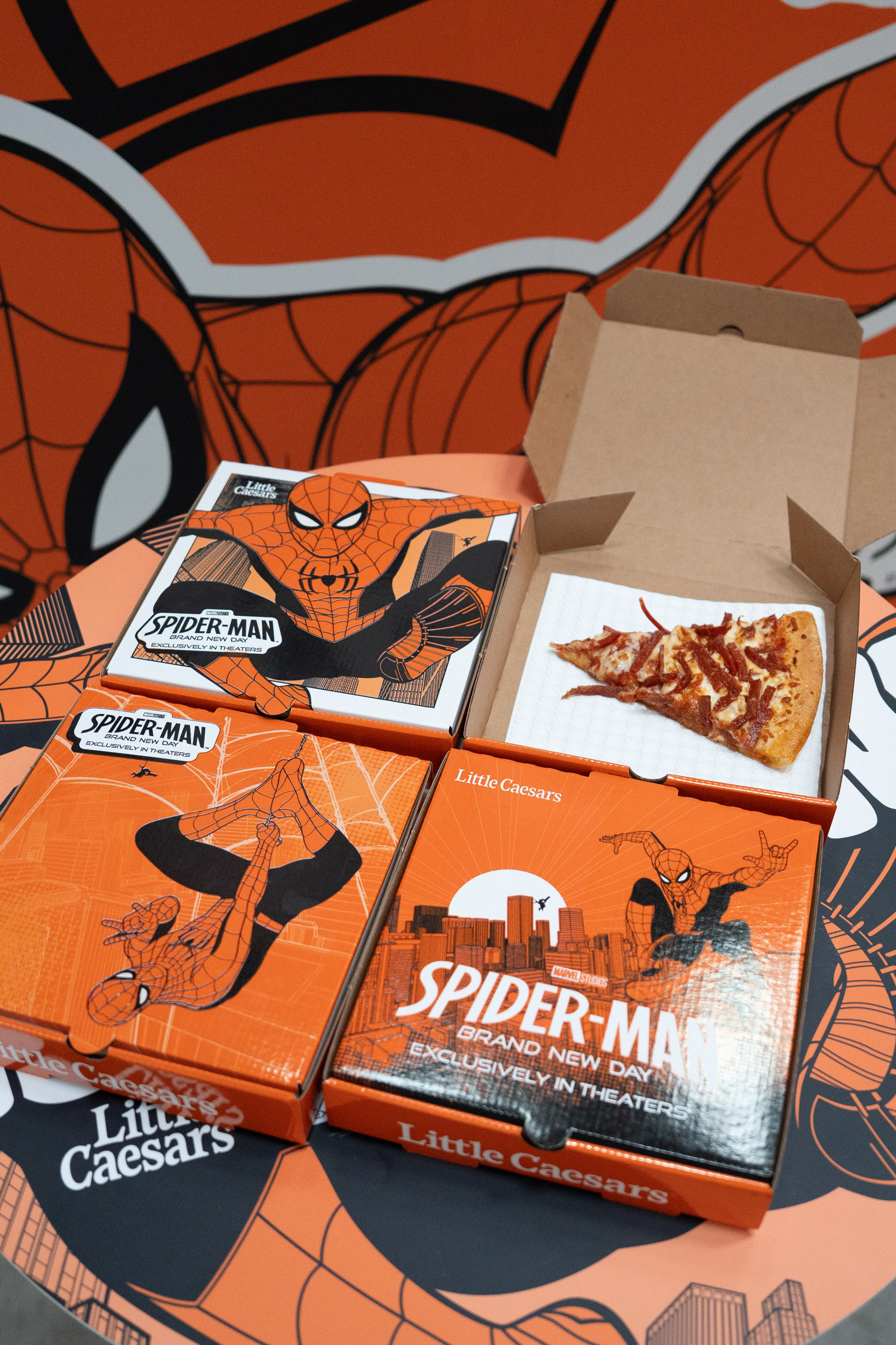 Close-up of the Spider-Man hanging graphic on the orange container wall